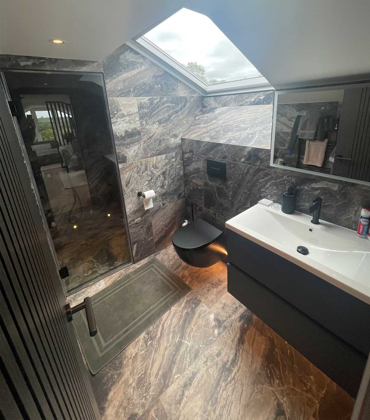 An ensuite bathroom and shower to a loft conversion bedroom installation built by topflite loft conversions in northwest england