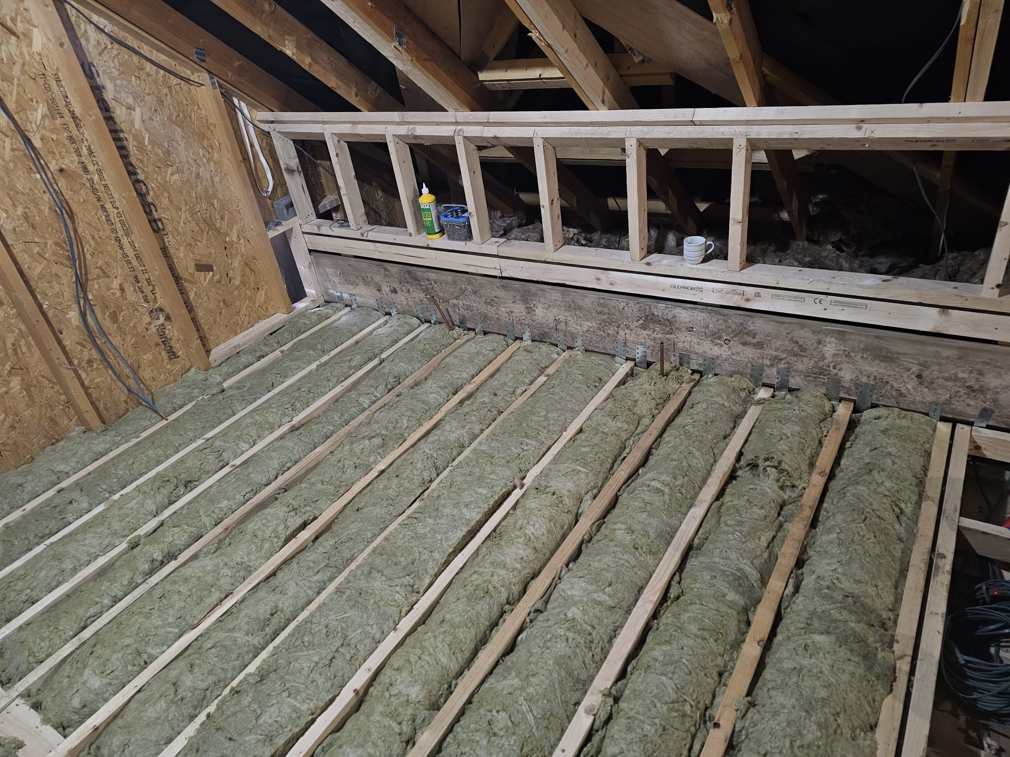 A loft conversion bedroom insulation installation built by topflite loft conversions in northwest england